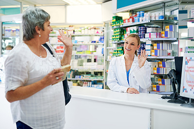 Buy stock photo Shot of a happy mature woman leaving a pharmacy after buying medication