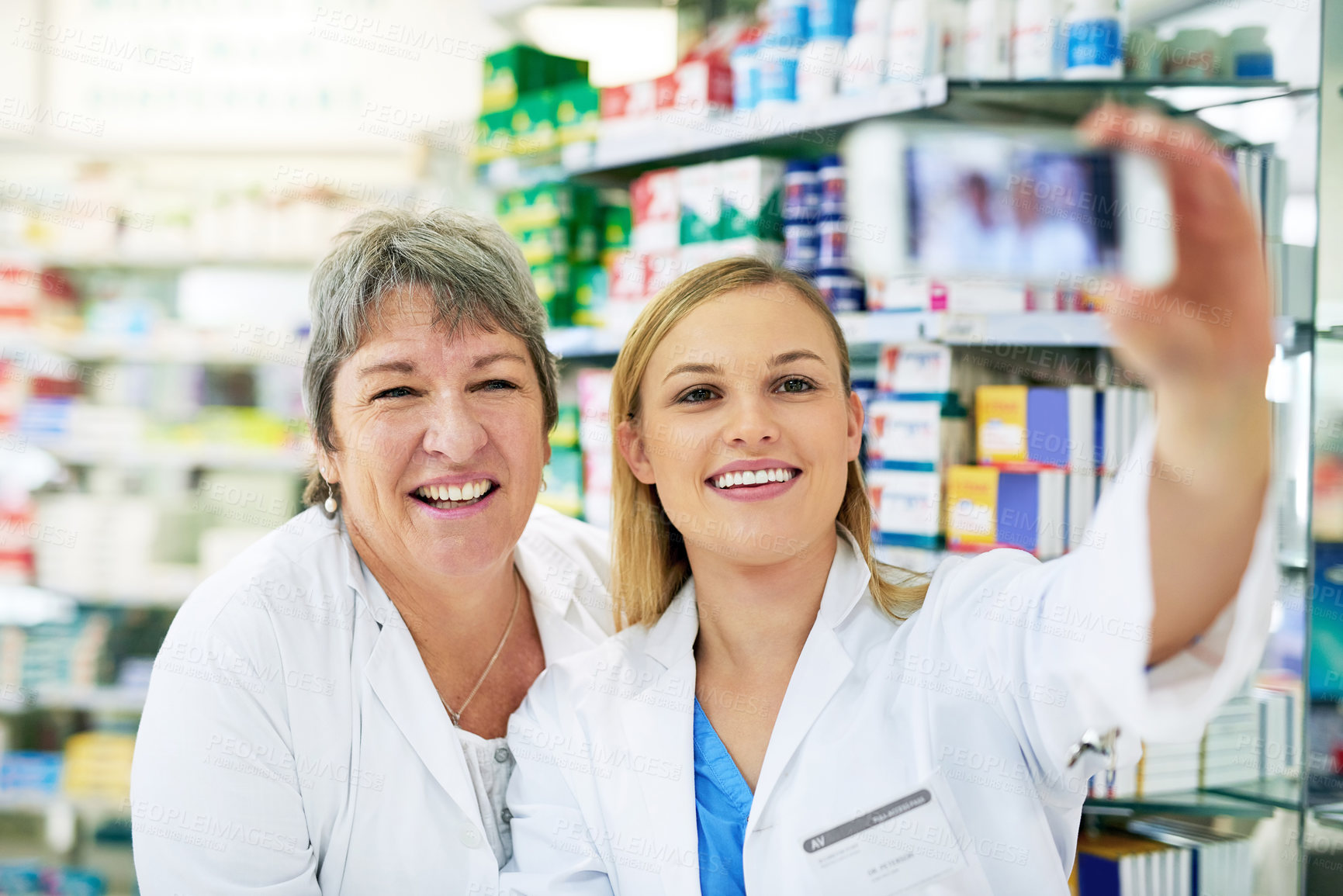 Buy stock photo Pharmacy, selfie and women with smile from teamwork and store success with social media update. Pharmacist, mature and happy with picture for company website and digital app at work in drugstore