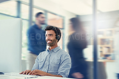Buy stock photo Cropped shot of a call centre agent working in a busy office