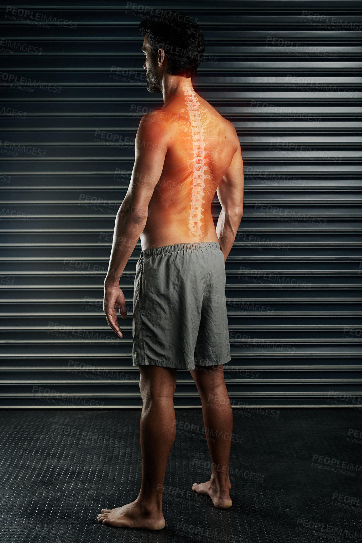 Buy stock photo Studio shot of a muscular young man with his spinal column showing through cgi