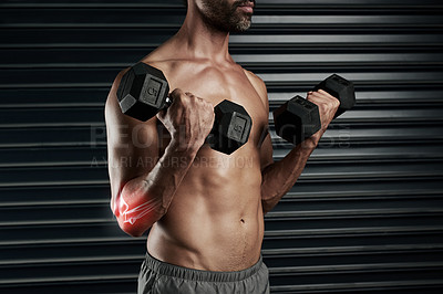 Buy stock photo Studio shot of a muscular young man lifting dumbbells with cgi highlighting his elbow