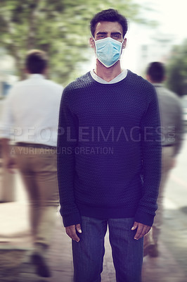 Buy stock photo Shot of a man wearing a surgical mask in a crowd