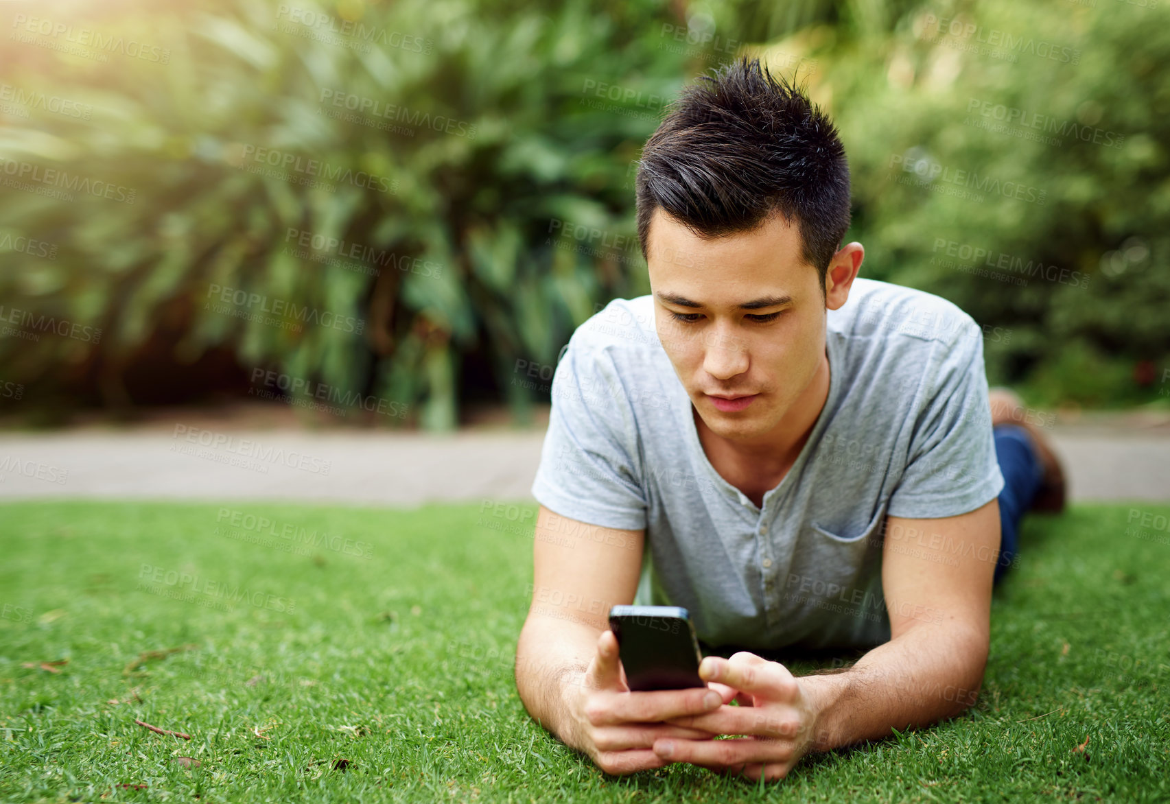 Buy stock photo Relax, internet and man on lawn with phone for social media, chat app and chill in nature. Guy, rest and mobile in botanical garden for plant research, ecology blog and website faq for climate change
