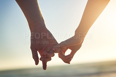 Buy stock photo Couple, holding hands and little finger at beach in close up with bonding, love and connection on vacation. People, partner and sunset for trust, care and pinky promise by sea on holiday in Greece