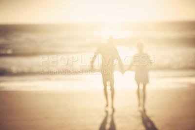 Buy stock photo Couple, holding hands and walk at beach with silhouette for bonding, love or connection on vacation. People, partner and together for support with kindness for trust, care or holiday by sea in Greece