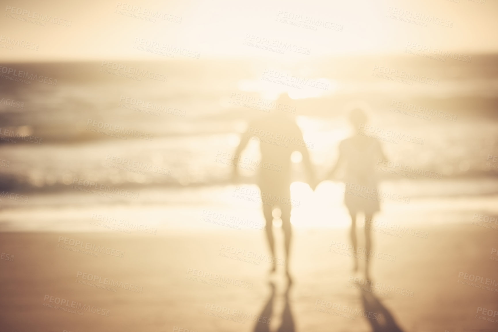 Buy stock photo Couple, holding hands and walk at beach with silhouette for bonding, love or connection on vacation. People, partner and together for support with kindness for trust, care or holiday by sea in Greece