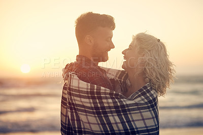 Buy stock photo Cropped shot of an affectionate young couple enjoying their time on the beach