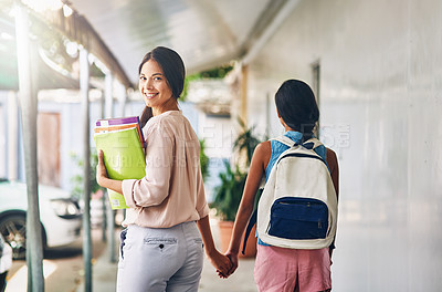 Buy stock photo Portrait of an attractive young teacher walking one of her students to class