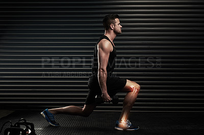 Buy stock photo Full length shot of an athletic young man working out with dumbbells in the studio