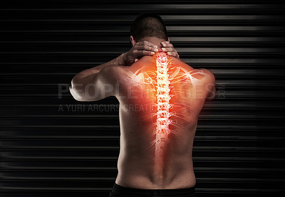 Buy stock photo Rearview shot of an athletic young man suffering with a back injury in the studio
