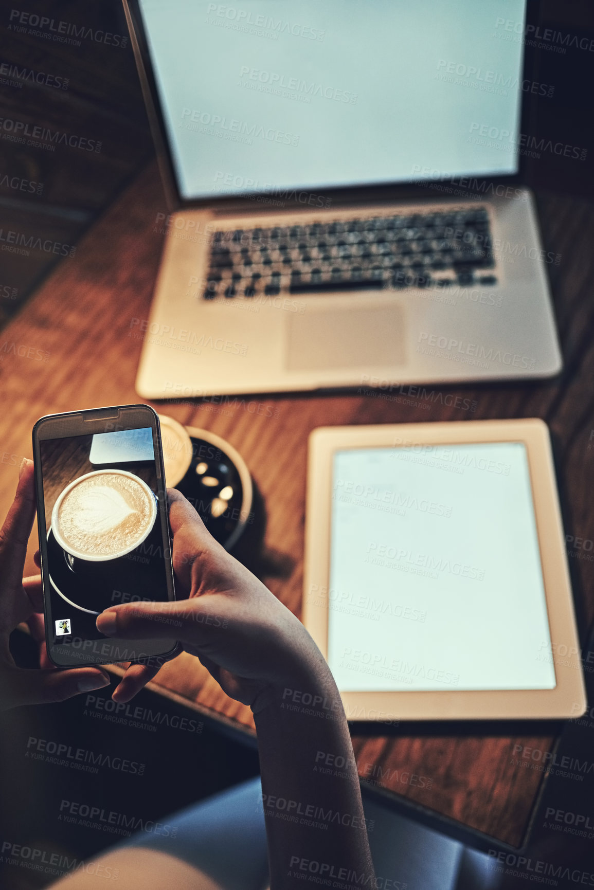 Buy stock photo Hands, phone and technology screen in cafe for product placement, website logo or social media marketing. Laptop, tablet and table with person on mobile at coffee shop, mockup space for restaurant