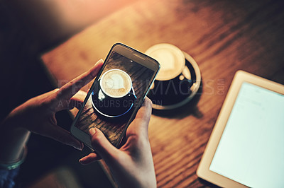 Buy stock photo Shot of an unidentifiable young woman using wireless technology in a coffee shop
