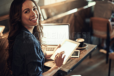 Buy stock photo Portrait of a relaxed young woman using wireless technology in a coffee shop
