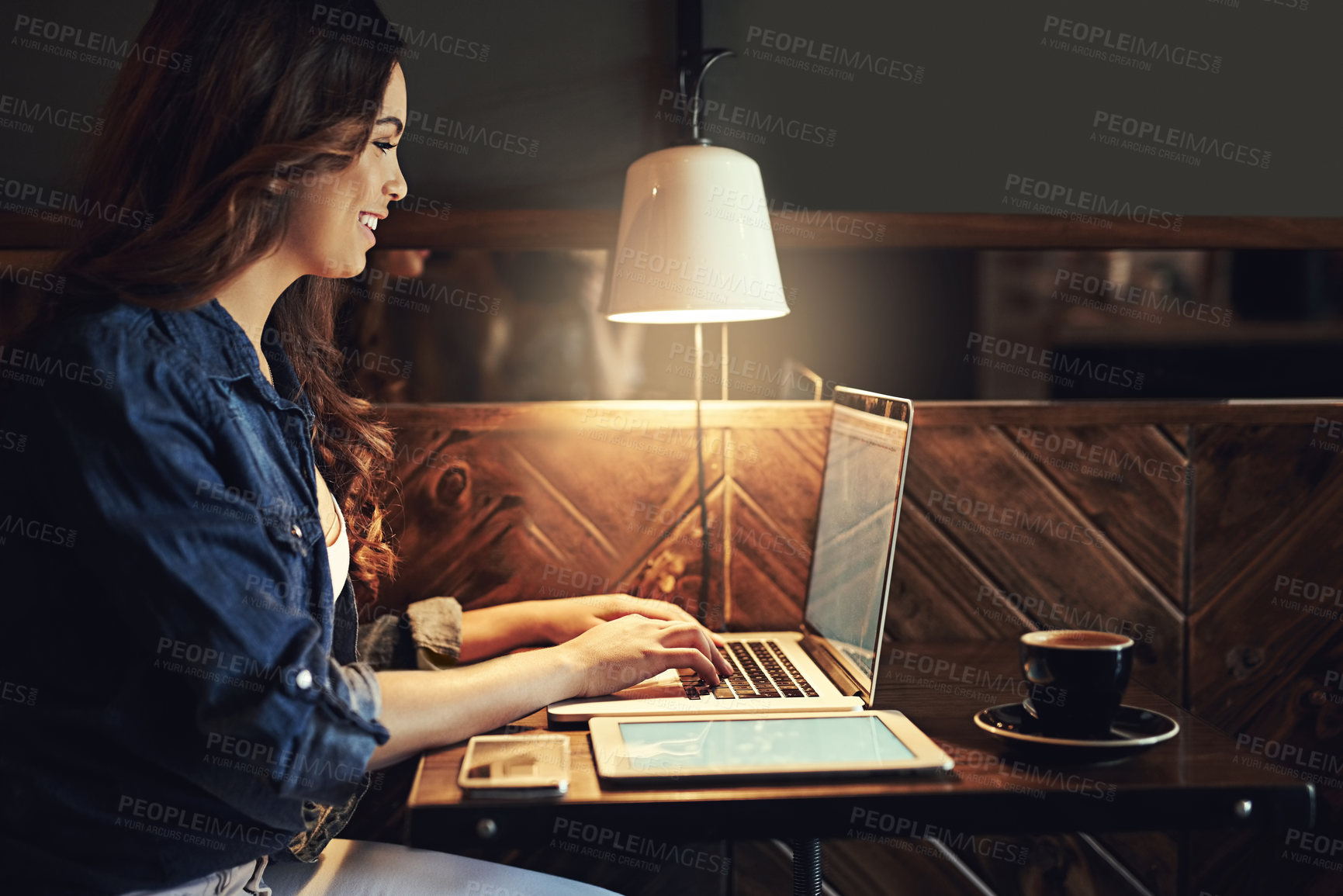 Buy stock photo Woman, laptop and freelancer at night in cafe, copywriter and research for article deadline. Female person, profile and writing feature for column in coffee shop, planning and online for remote work