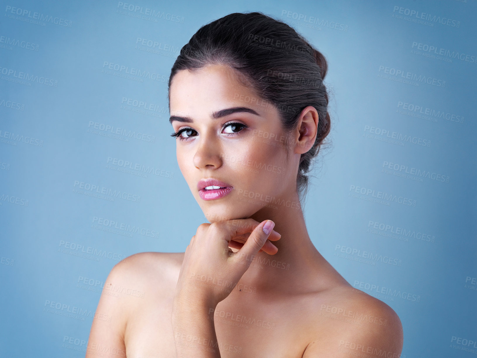 Buy stock photo Beauty, skincare and portrait of woman in studio with natural makeup, confidence and luxury cosmetics. Dermatology, facial care and girl with shine, wellness and healthy skin glow on blue background.