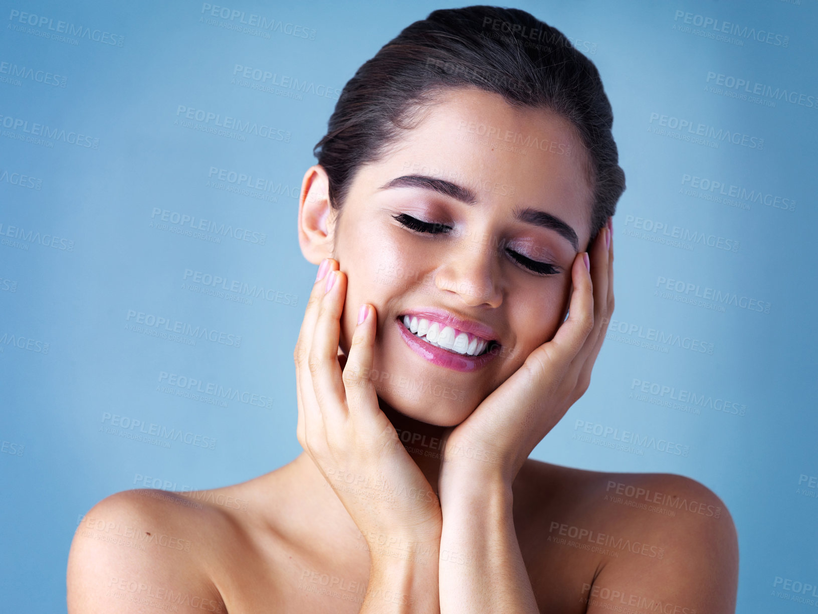 Buy stock photo Studio, makeup and woman with smile for beauty, facial glow and natural shine with wellness. Skin health, dermatology and model girl with skincare for spa aesthetic and cosmetic by blue background