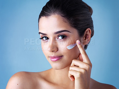 Buy stock photo Skincare, portrait of woman with face cream and in blue background. Beauty, cosmetic treatment and happy female model pose with sunscreen for skin care or health wellness in studio backdrop.