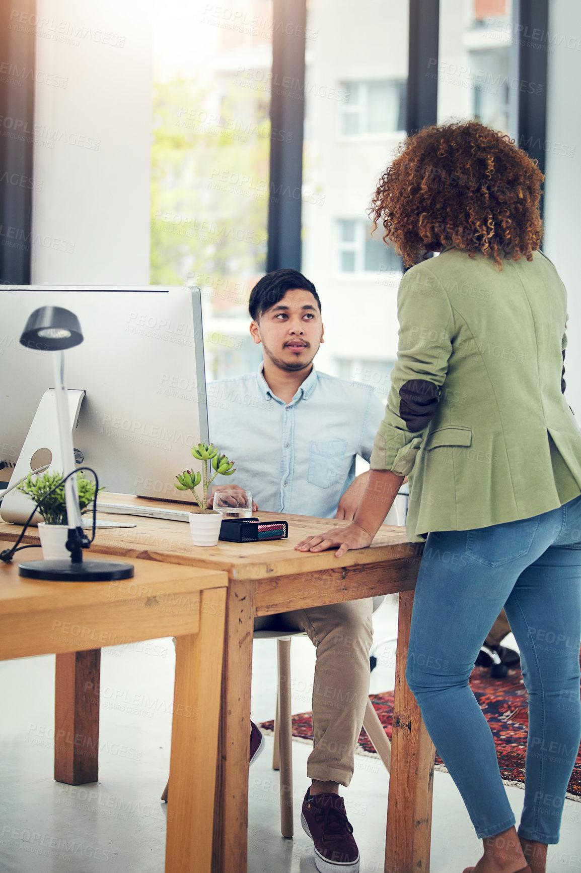 Buy stock photo Shot of two creative colleagues working together in their office