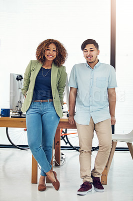 Buy stock photo Portrait of two happy creatives posing together in their office