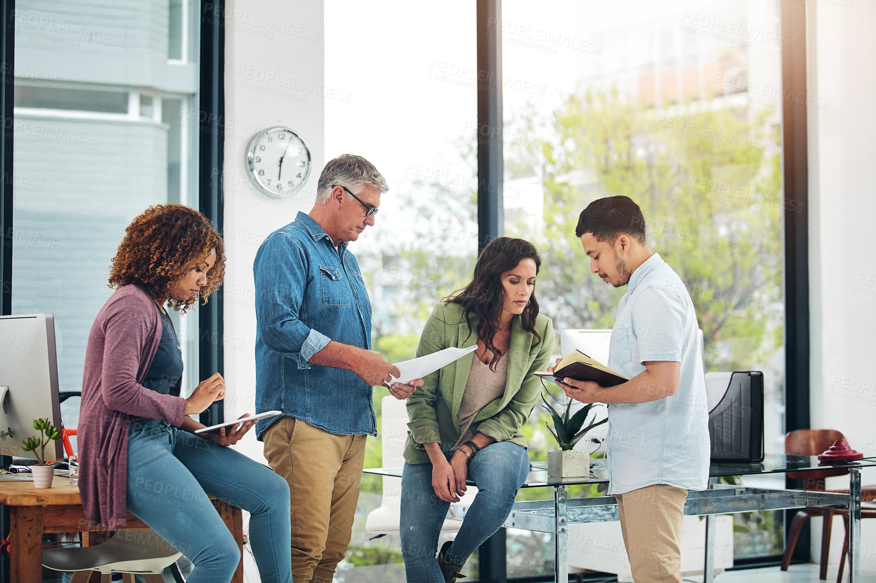 Buy stock photo Shot of a group of creative colleagues exchanging ideas in their office