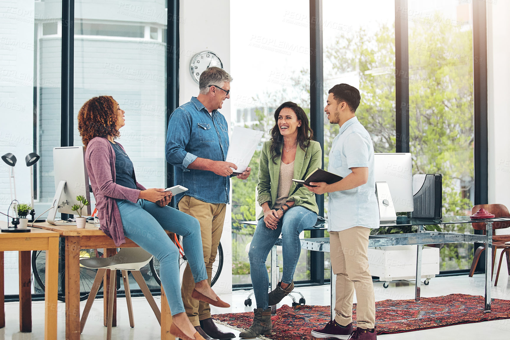 Buy stock photo Shot of a group of creative colleagues exchanging ideas in their office