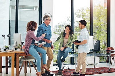 Buy stock photo Shot of a group of creative colleagues exchanging ideas in their office