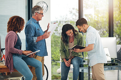 Buy stock photo Shot of a group of creative colleagues exchanging ideas in their office