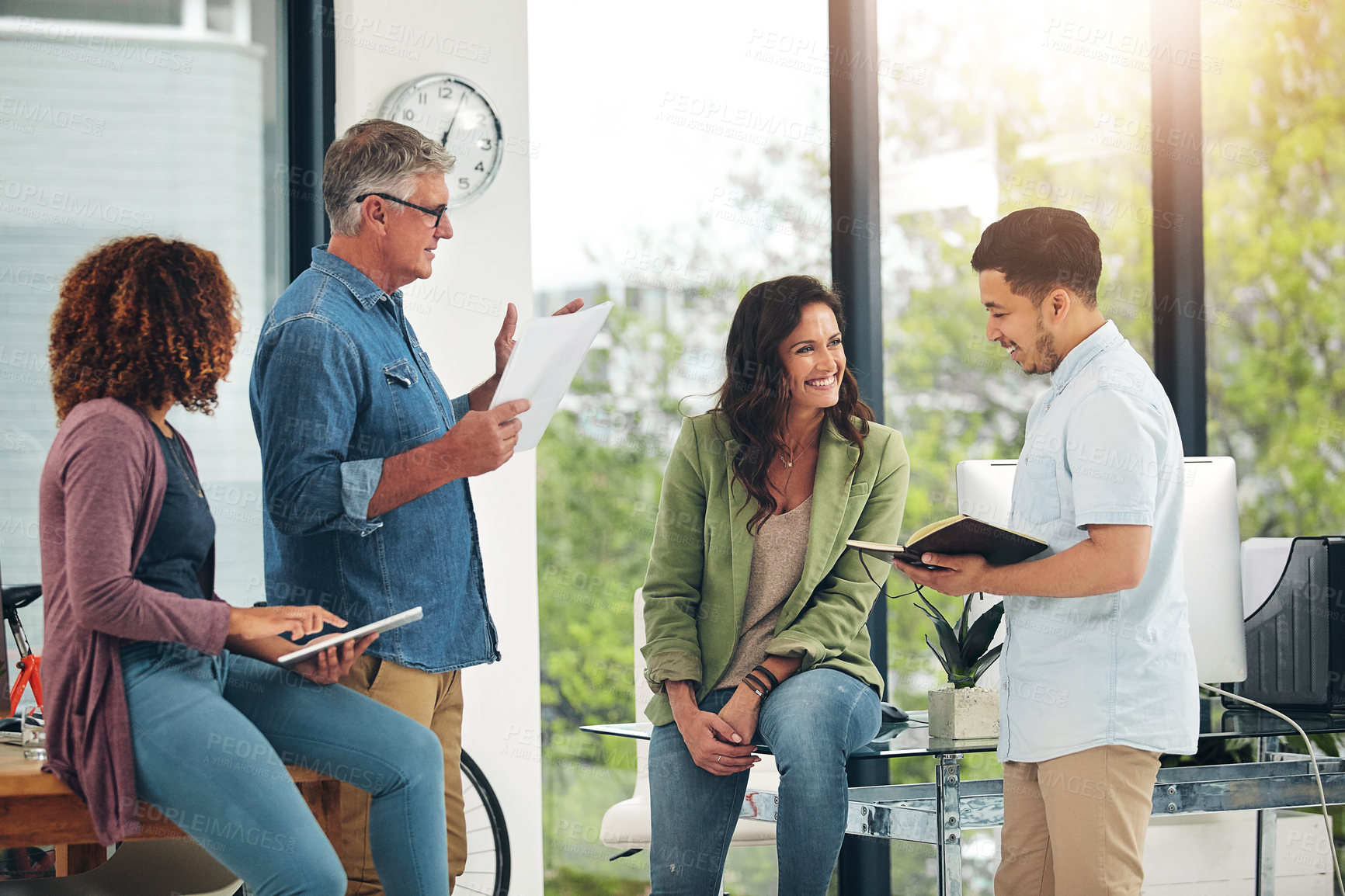 Buy stock photo Shot of a group of creative colleagues exchanging ideas in their office