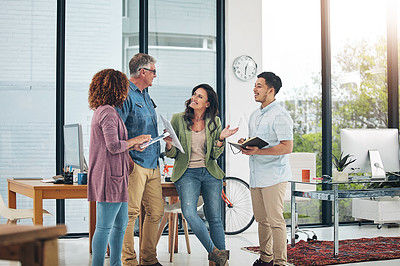 Buy stock photo Shot of a group of creative colleagues exchanging ideas in their office