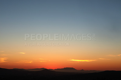 Buy stock photo Shot of a beautiful sky over a mountain range just after sunset