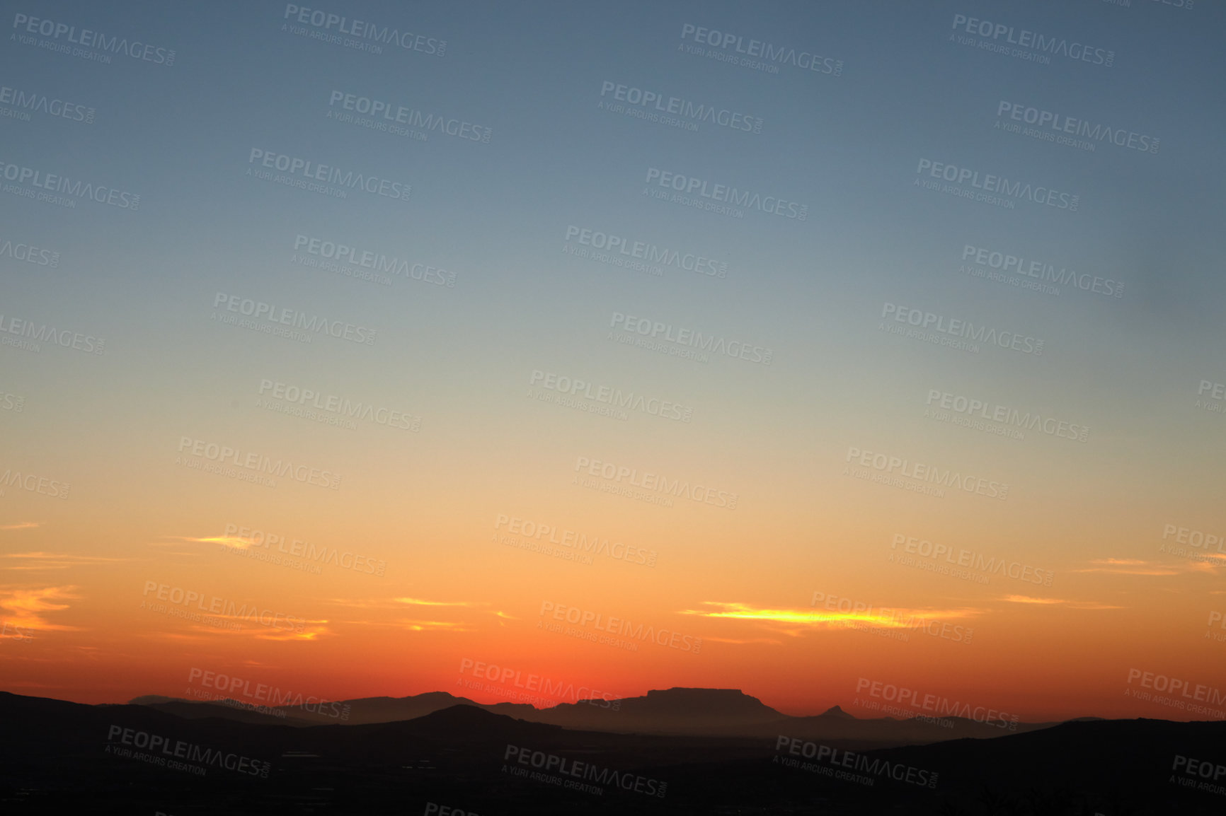 Buy stock photo Shot of a beautiful sky over a mountain range just after sunset