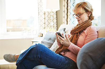 Buy stock photo Home, phone or mature woman on social media with internet connection or website notification on sofa. Glasses, search or senior person texting on networking mobile app chat or reading news to relax