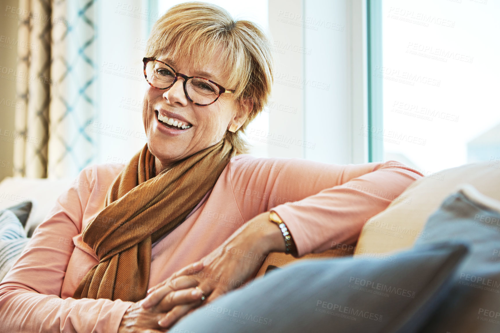 Buy stock photo Portrait, laugh or mature woman on couch to relax with happiness on living room sofa at home. Funny, happy or senior person with smile, peace or wellness in retirement, lounge or house for resting 