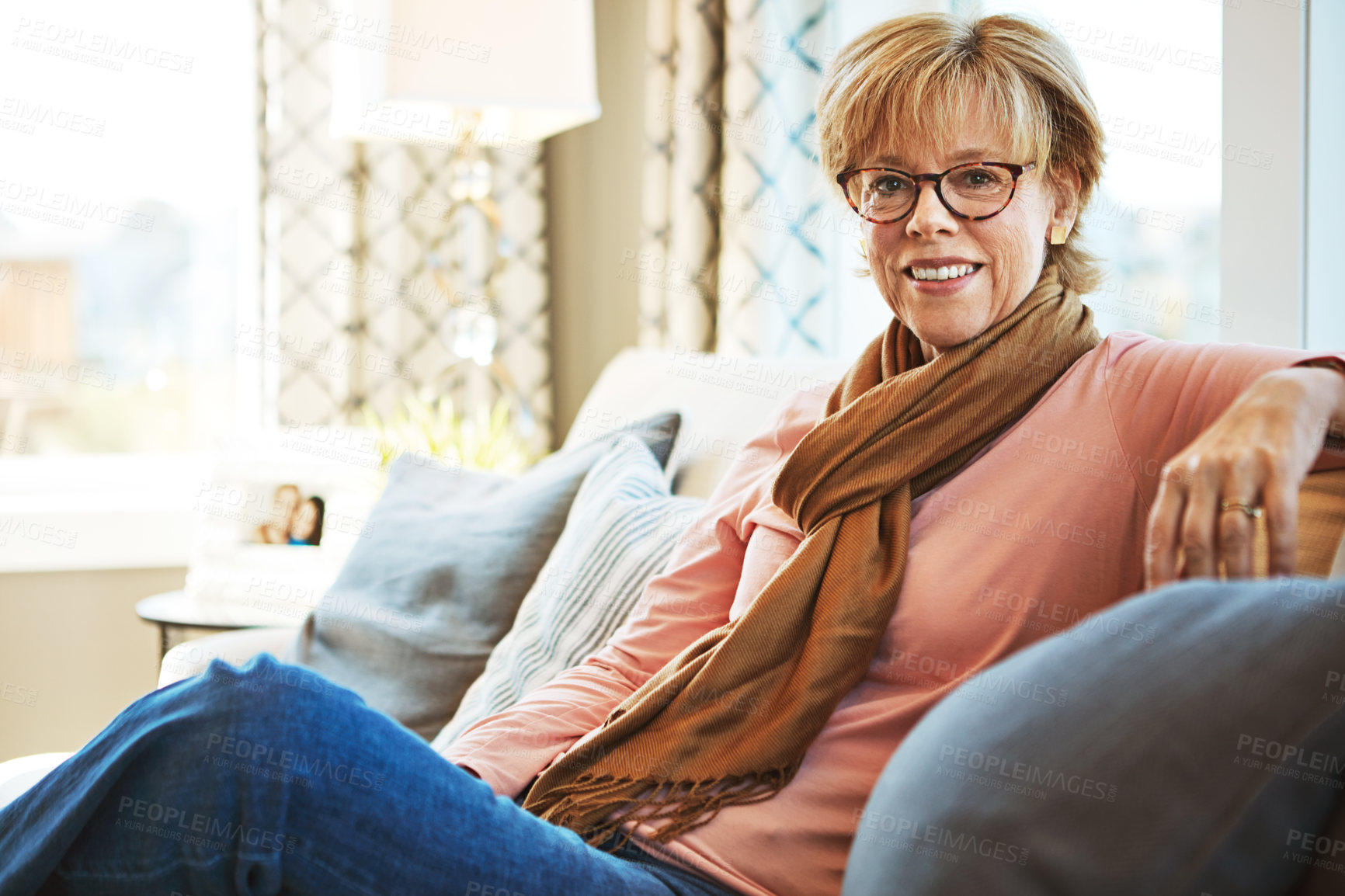 Buy stock photo Portrait, mature or happy woman on sofa to relax with freedom on living room couch at home. Apartment, glasses or senior lady with smile, peace or wellness in retirement, lounge or house for resting