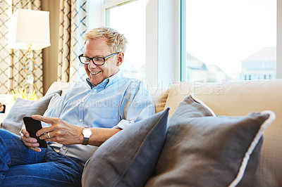 Buy stock photo Mature, phone or happy man on social media with internet connection or website notification on sofa. House, search or senior person texting on networking mobile app chat or reading news to relax 