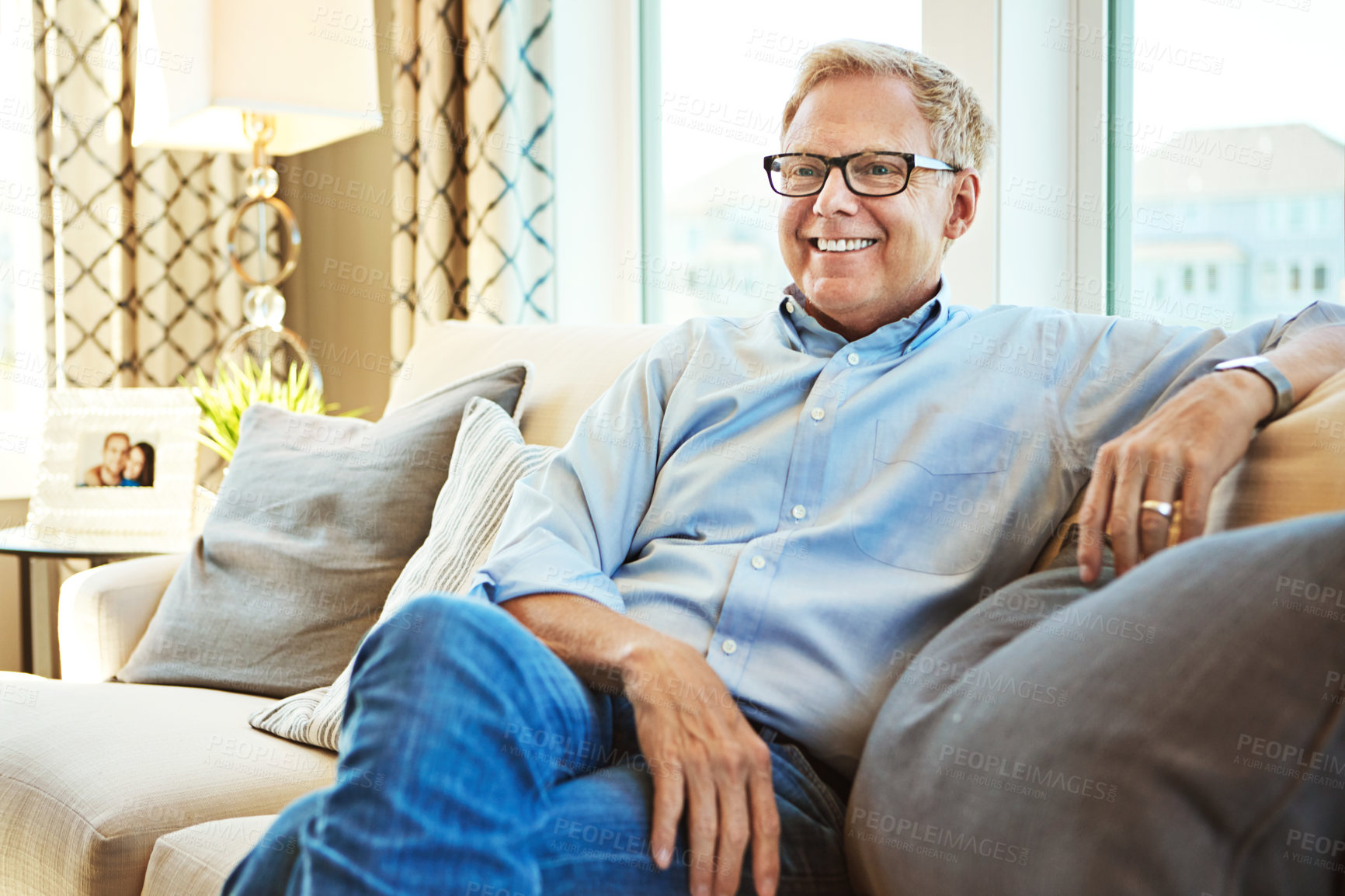 Buy stock photo Thinking, mature or happy man on sofa to relax with calm on living room couch at home for resting. Ideas, glasses or senior male person with smile, peace or wellness in retirement, lounge or house