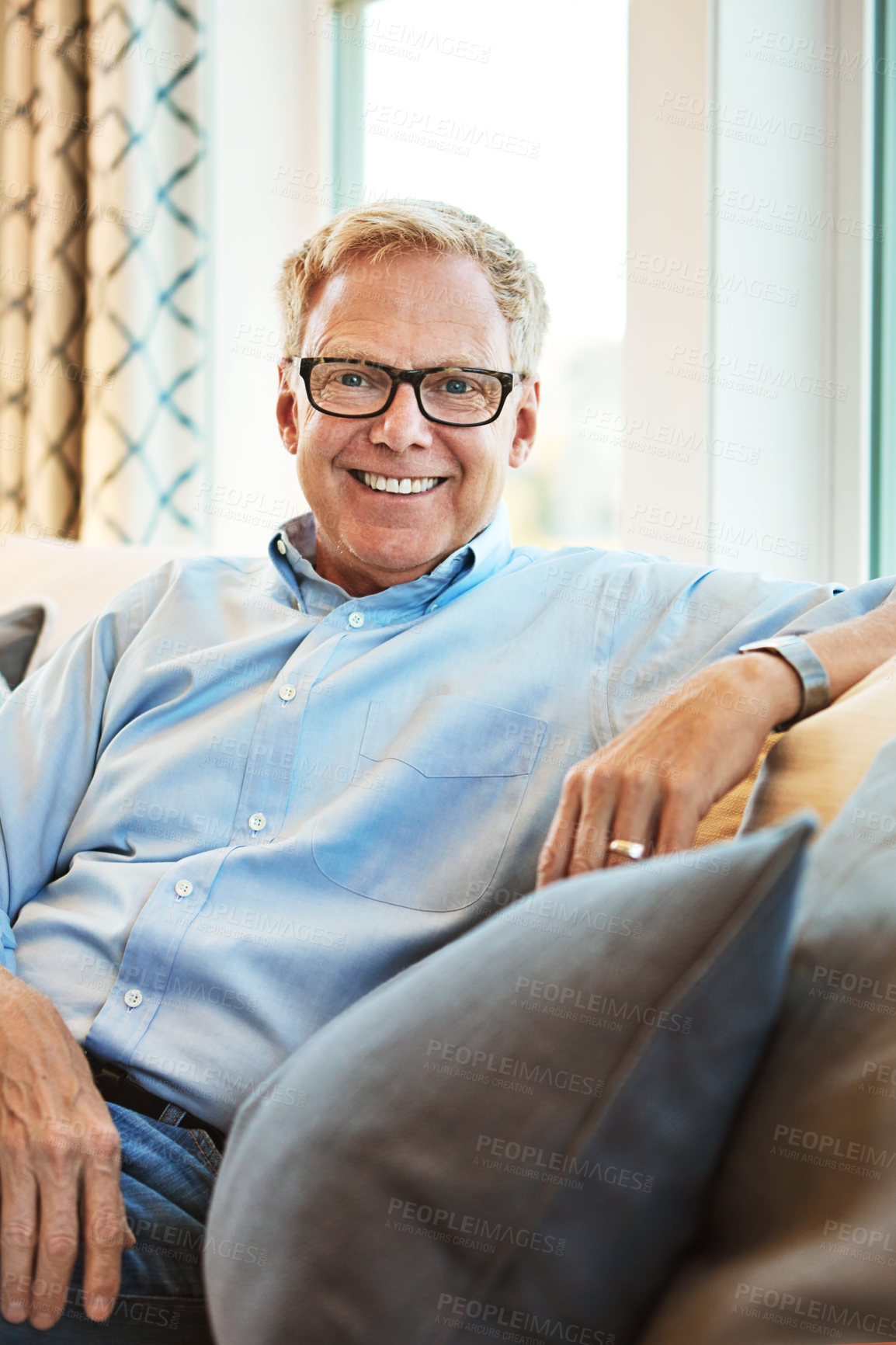 Buy stock photo Portrait, mature or happy man in living room to relax with freedom on couch or sofa at home. Apartment, face or senior person with smile or wellness in retirement, lounge or house for resting break 