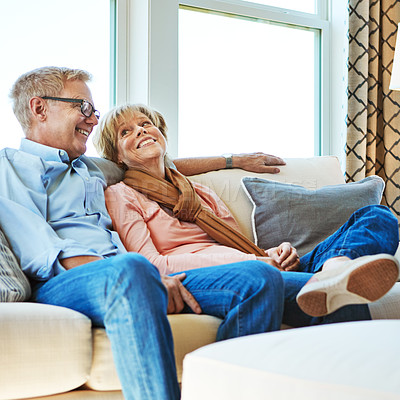 Buy stock photo Laughing, mature or happy couple in home to relax, enjoy conversation or joke together in retirement. Care, funny woman or senior man talking with love, support or smile on house living room couch