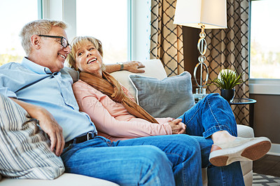 Buy stock photo Speaking, mature or happy couple in house to relax, enjoy conversation or joke together in retirement. Care, funny woman or senior man laughing with love, support or smile on home living room couch