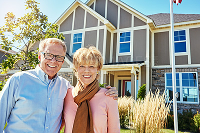 Buy stock photo Portrait of a happy senior couple posing outside their new home