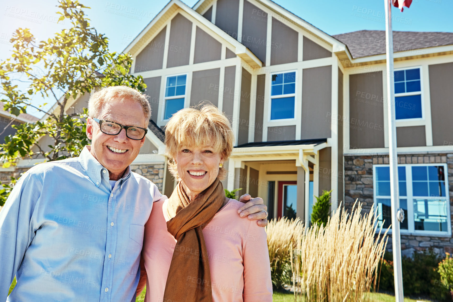 Buy stock photo Portrait of a happy senior couple posing outside their new home