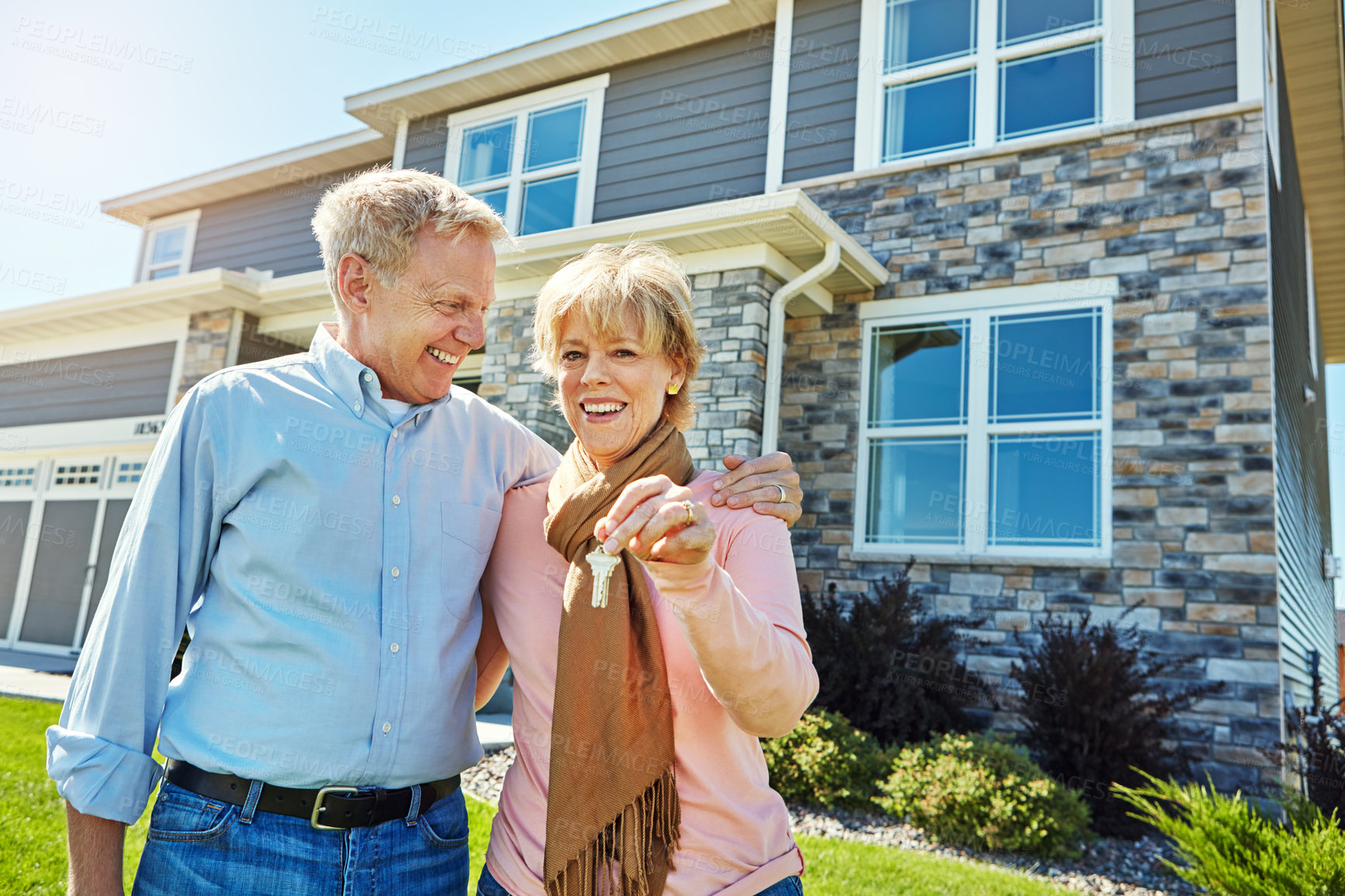 Buy stock photo Portrait of a happy senior couple posing outside their new home