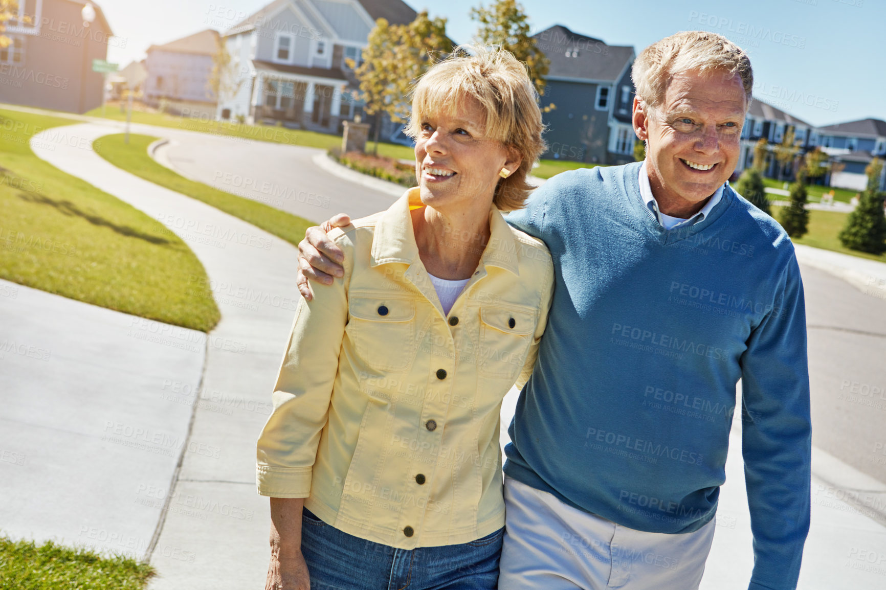 Buy stock photo Shot of a happy senior couple waking around their neighborhood together