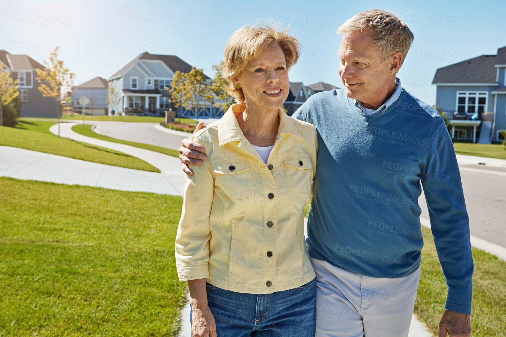 Buy stock photo Shot of a happy senior couple waking around their neighborhood together