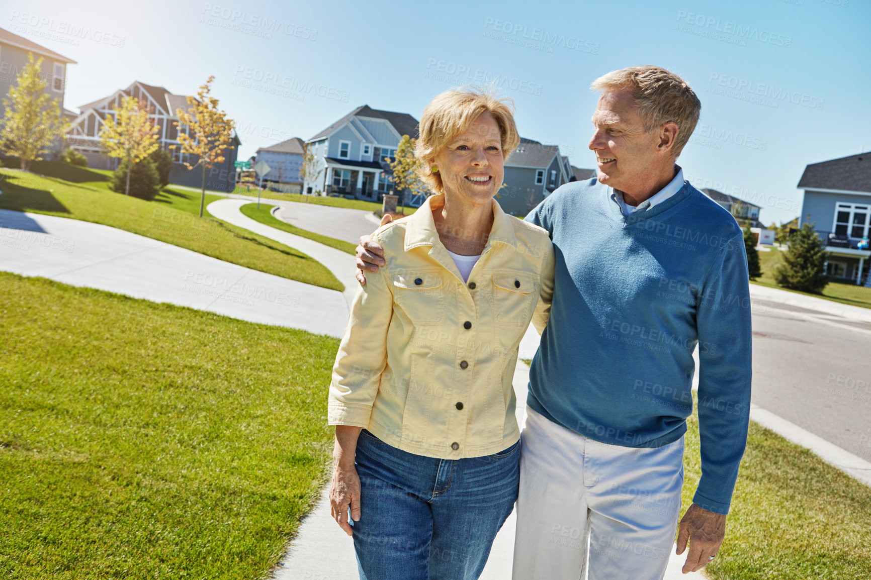 Buy stock photo Shot of a happy senior couple waking around their neighborhood together