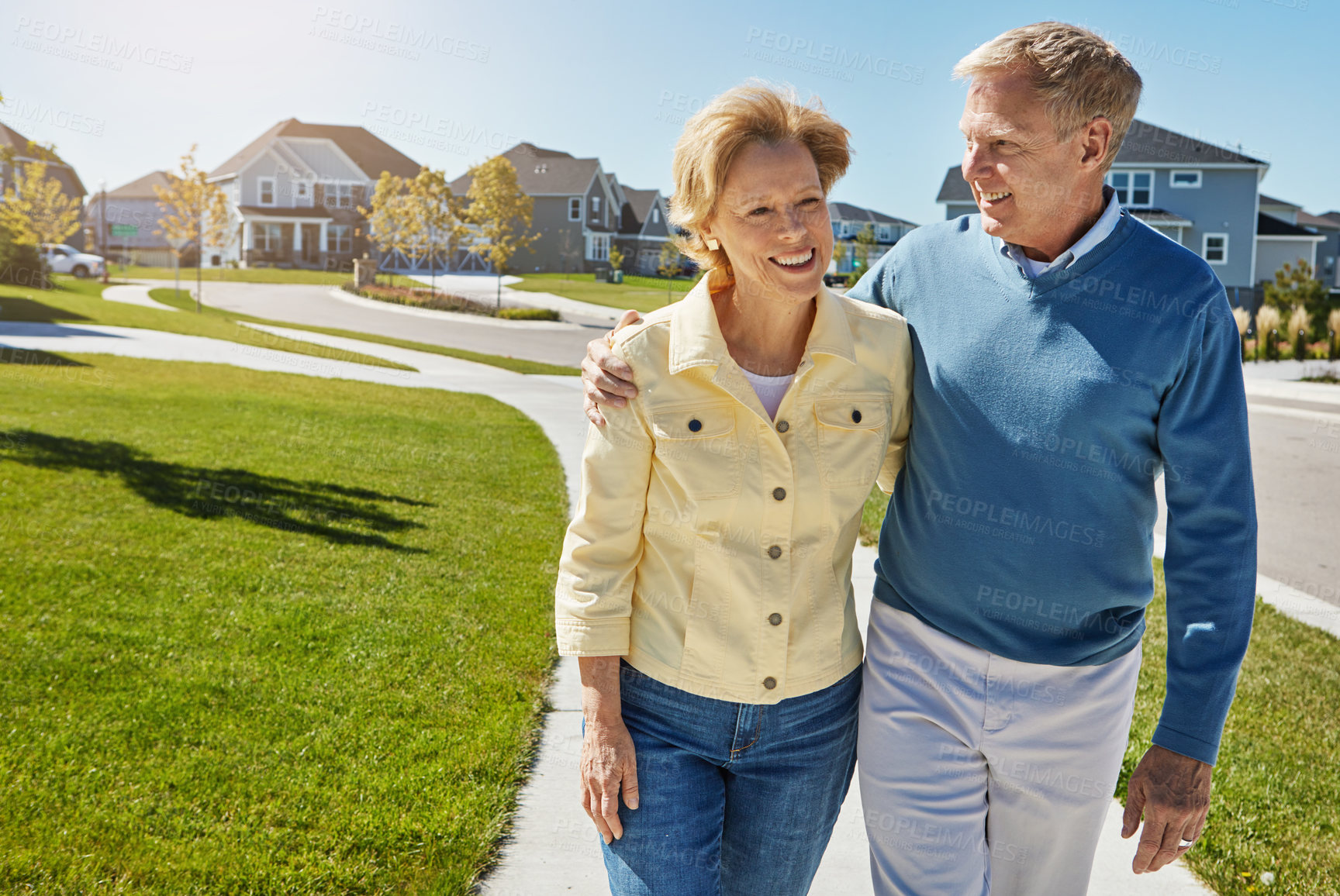 Buy stock photo Shot of a happy senior couple waking around their neighborhood together