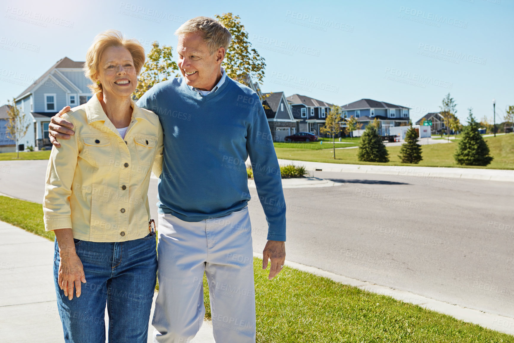 Buy stock photo Shot of a happy senior couple waking around their neighborhood together