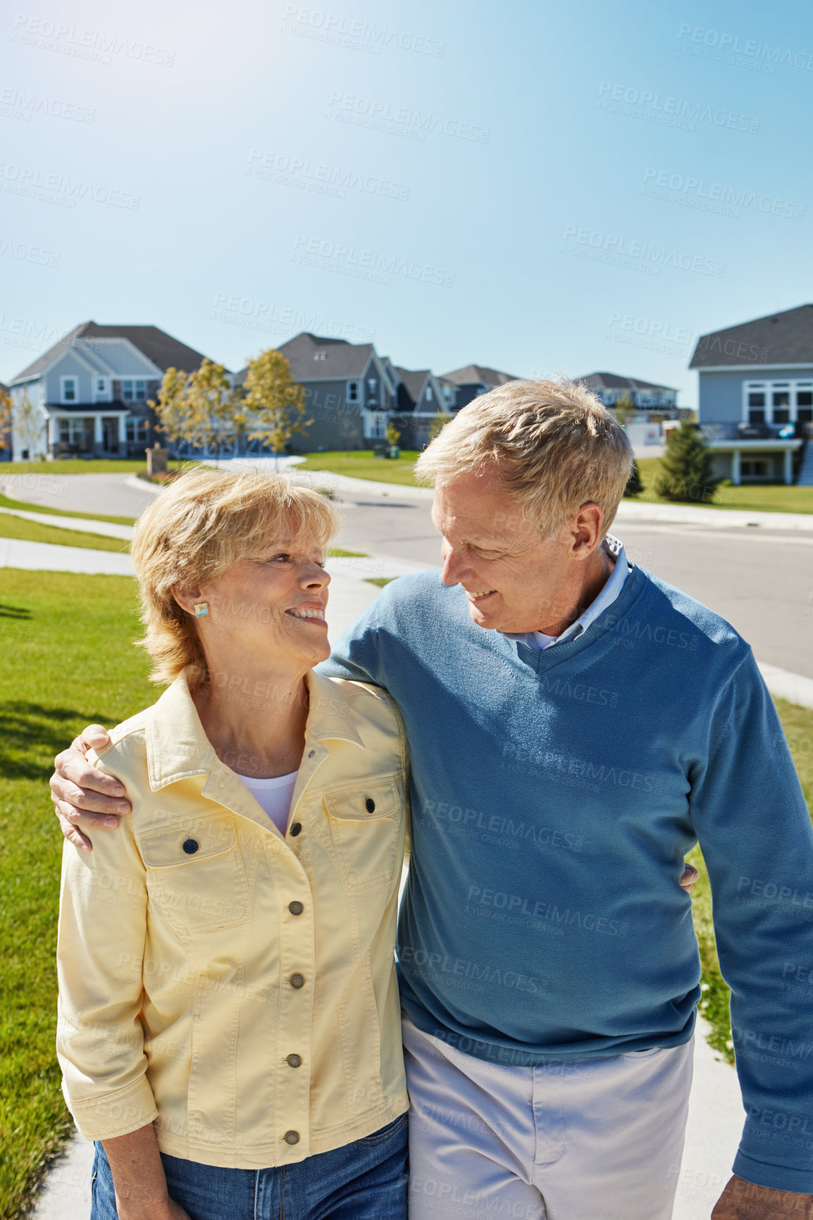 Buy stock photo Shot of a happy senior couple waking around their neighborhood together