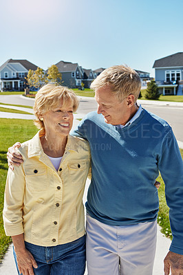 Buy stock photo Shot of a happy senior couple waking around their neighborhood together