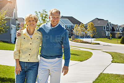 Buy stock photo Shot of a happy senior couple waking around their neighborhood together